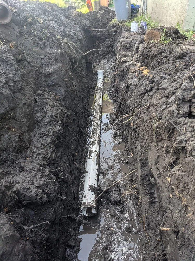New PVC sewer pipe laid in an open trench