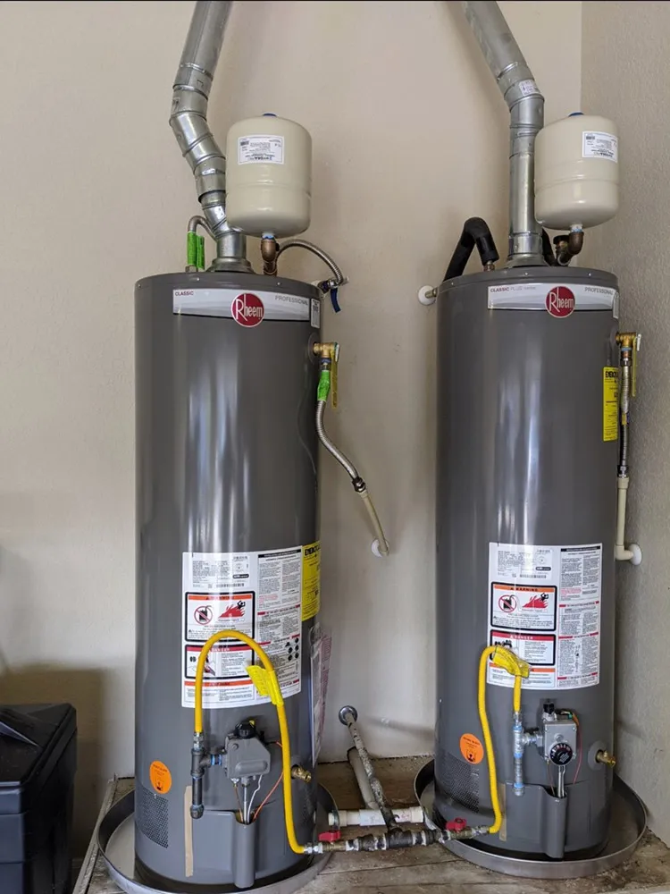 Two new gas water heaters with expansion tanks installed side by side
