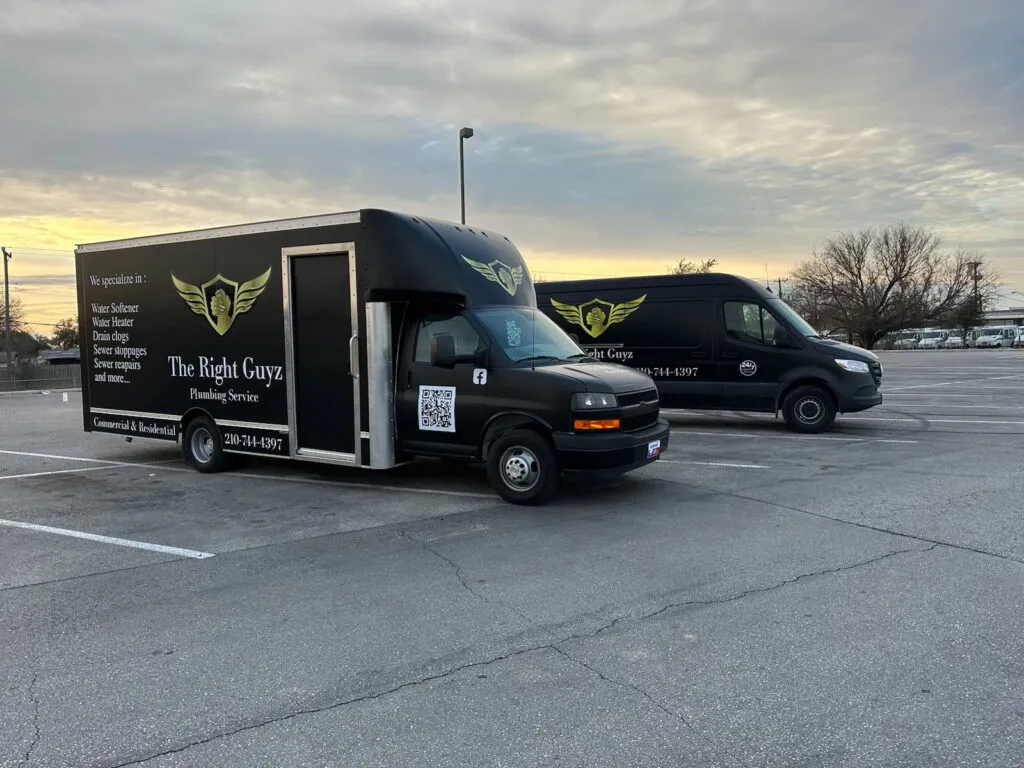 Two Right Guyz Plumbing service trucks parked and ready to roll at sunrise
